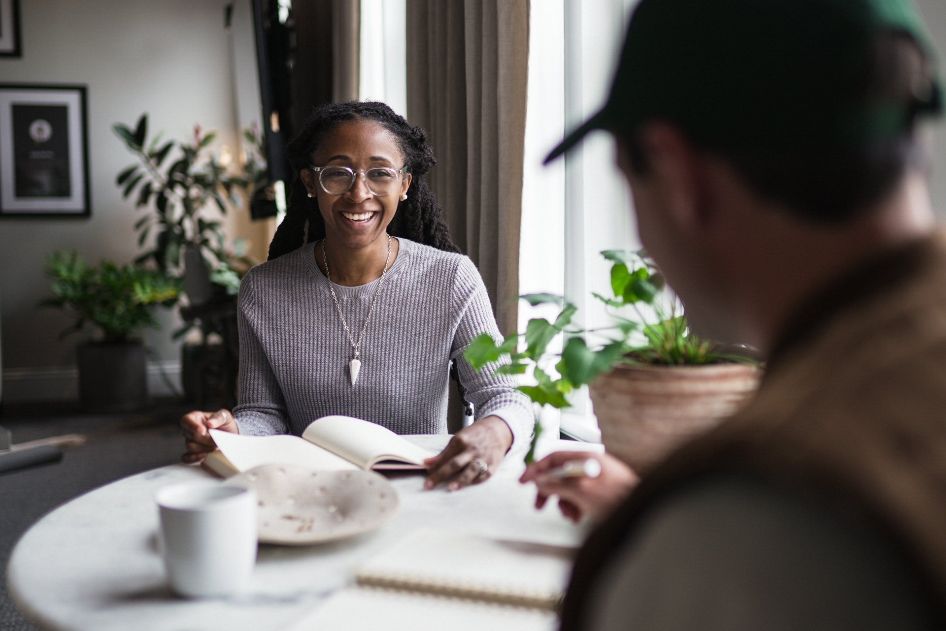 Woman smiling while using a planner at a table